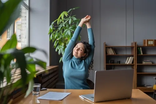 Happy,Businesswoman,Warming,Up,Body,And,Muscles,At,Workplace,,Feeling